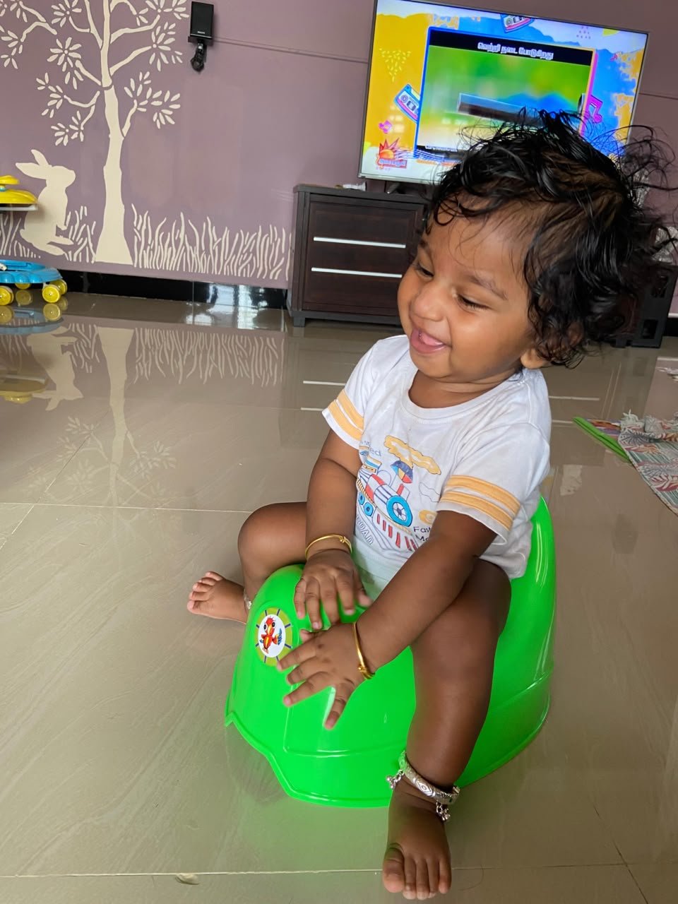Dhuruvan smiling while playing at home